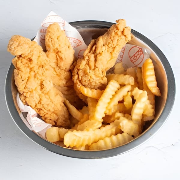 Crispy fried chicken tenders and crinkle-cut fries in a metal bowl, lined with branded paper.